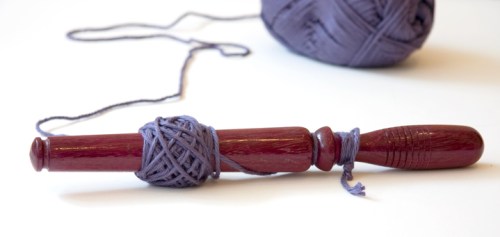 Image of a nostepinne with yarn.